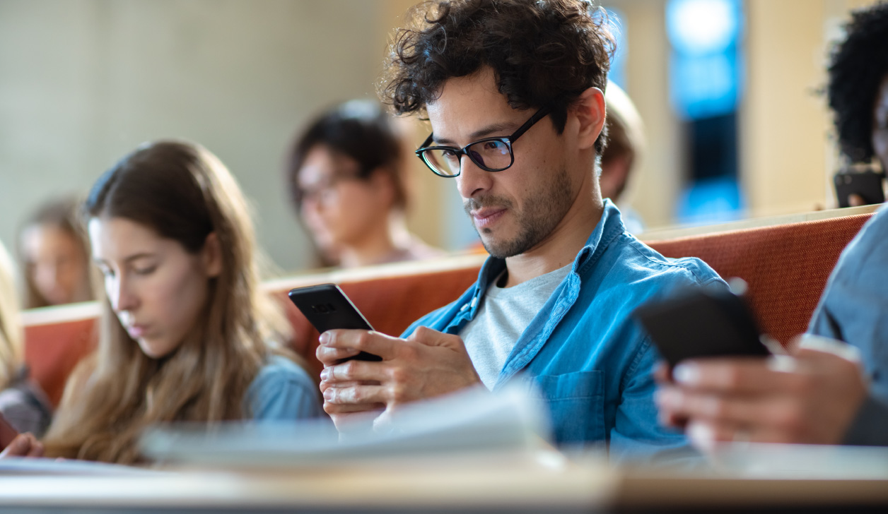 College students using phones during lecture